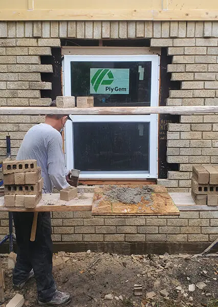 A man working on the outside of a building